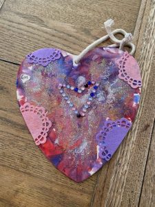 Displays valentines day hearts as part of arts and crafts