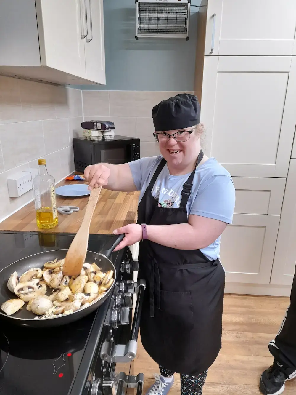 person cooking with team member