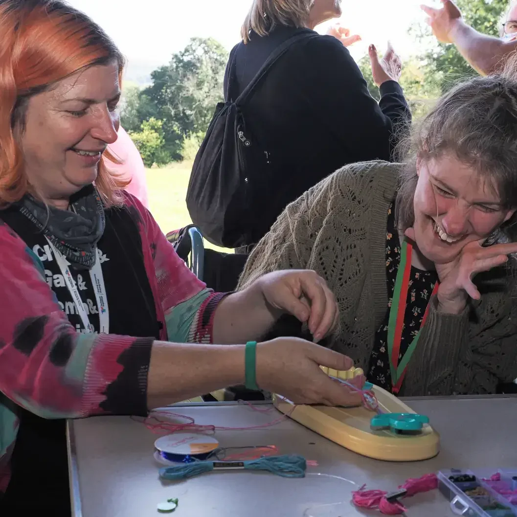 2) Support worker speaking with a person with warmth and focus