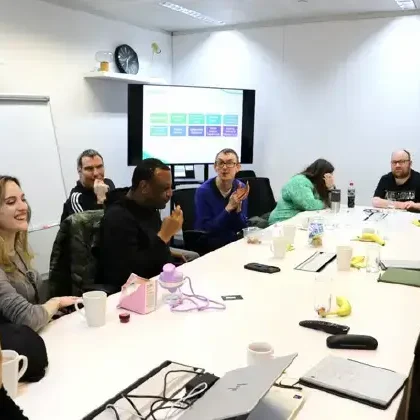 3) A support team around a table with risk tools in view