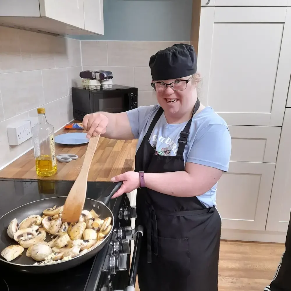 person cooking with team member