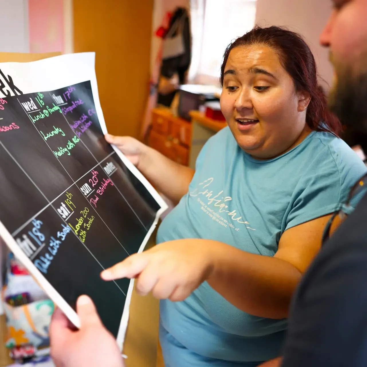 Photo-of-a-support-worker-and-young-person-working-on-a-visual-planner